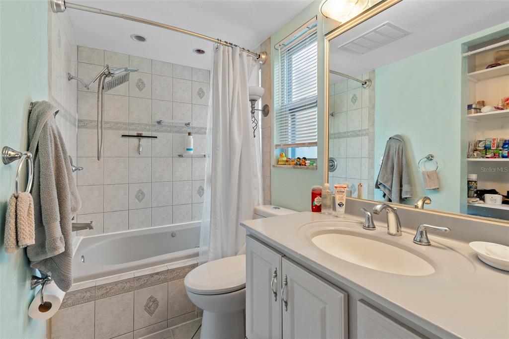 603 Ruskin Road Clearwater, FL 33765 - Photo 18 of 41 a bathroom with a granite countertop sink toilet and shower