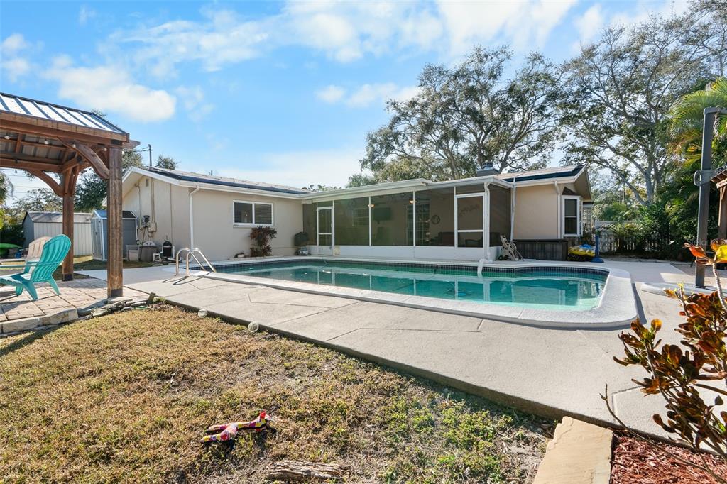 603 Ruskin Road Clearwater, FL 33765 - Photo 27 of 41 a view of a house with a small yard and sitting area