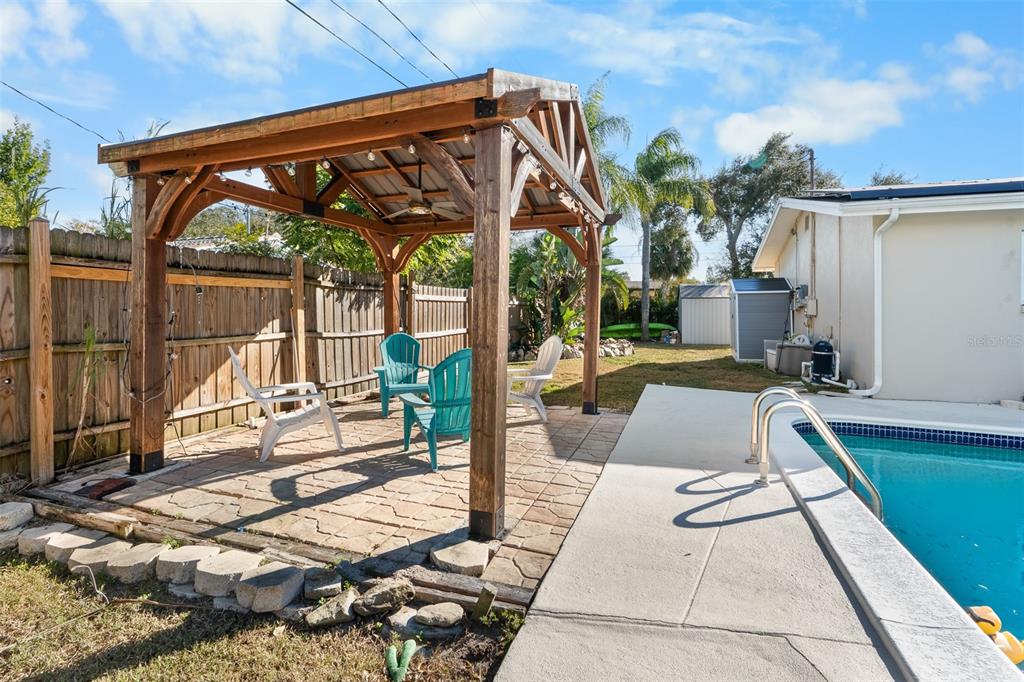 603 Ruskin Road Clearwater, FL 33765 - Photo 31 of 41 a view of backyard with swimming pool and patio