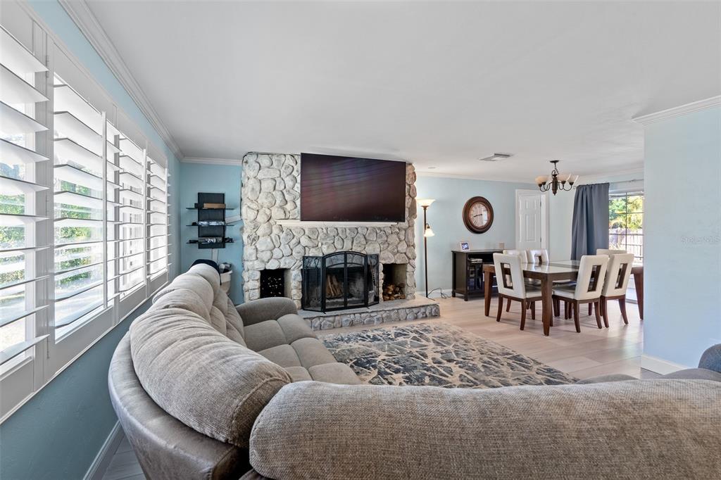 603 Ruskin Road Clearwater, FL 33765 - Photo 7 of 41 a living room with furniture a fireplace and a flat screen tv