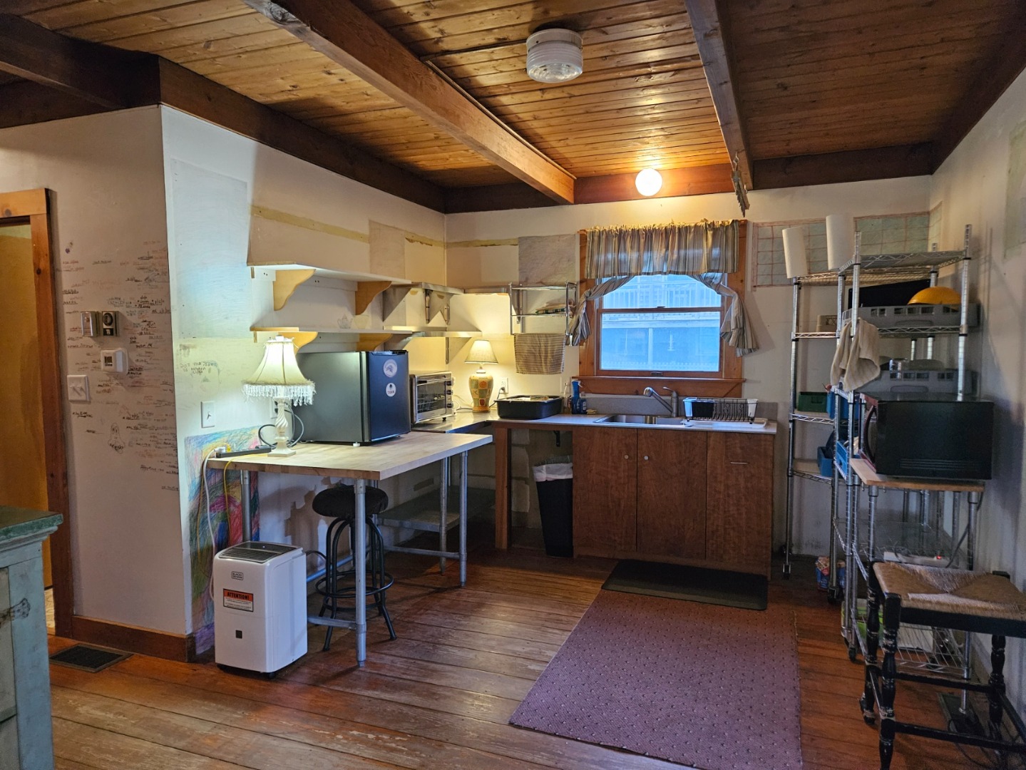 20 Leonard Circle Vineyard Haven, MA 02568 - Photo 2 of 16 a kitchen with a wooden floor and chairs