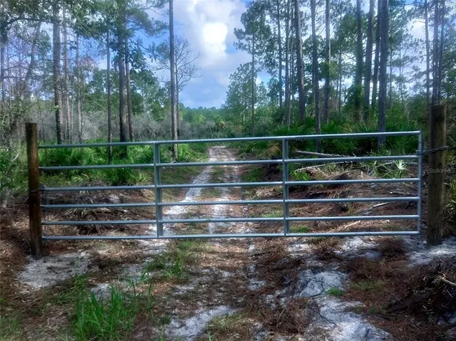 a view of park with wooden fence