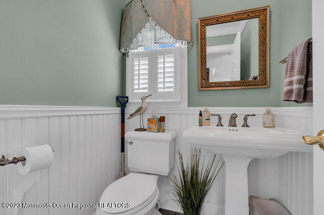 809 Lake Drive Spring Lake, NJ 07762 - Photo 14 of 34 a bathroom with a sink a toilet and mirror