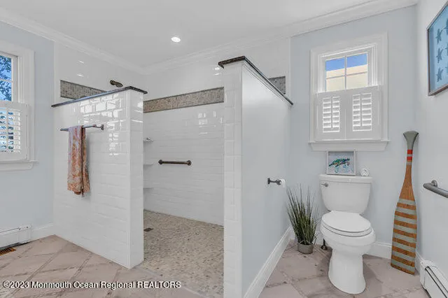 a bathroom with a toilet and a shower