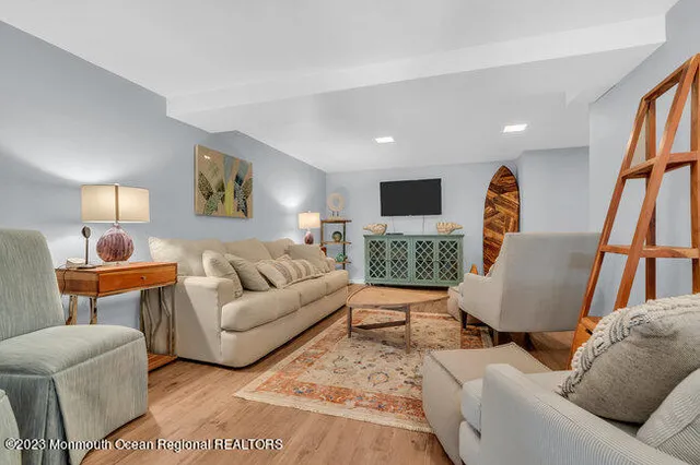 a living room with furniture and a wooden floor