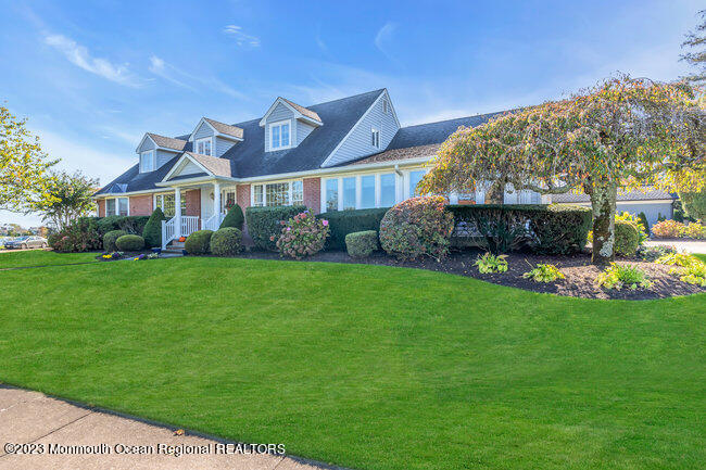 809 Lake Drive Spring Lake, NJ 07762 - Photo 2 of 34 a front view of a house with a garden