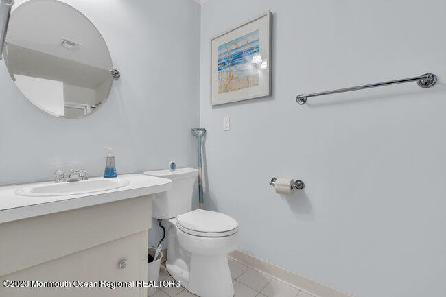 809 Lake Drive Spring Lake, NJ 07762 - Photo 23 of 34 a bathroom with a toilet a sink and mirror