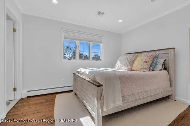 a bed sitting in a bedroom next to a window