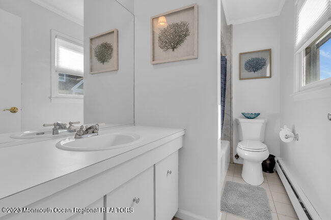 809 Lake Drive Spring Lake, NJ 07762 - Photo 25 of 34 a bathroom with a toilet a sink and mirror