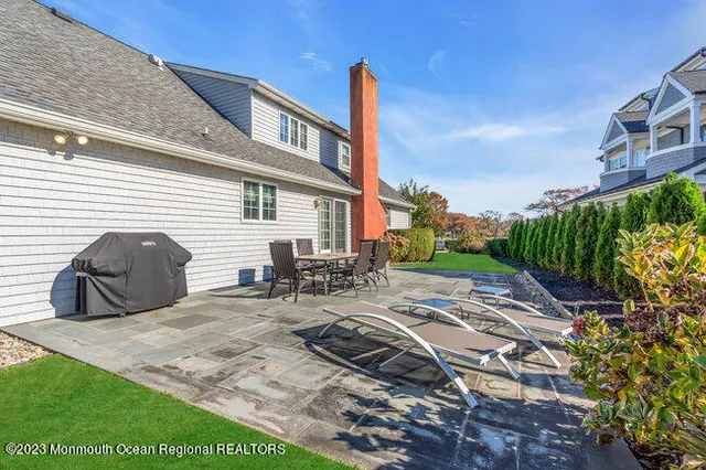a view of a chair and table in backyard