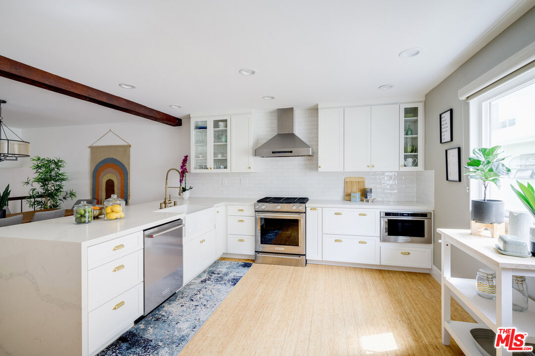 a kitchen with a white stove top oven and sink