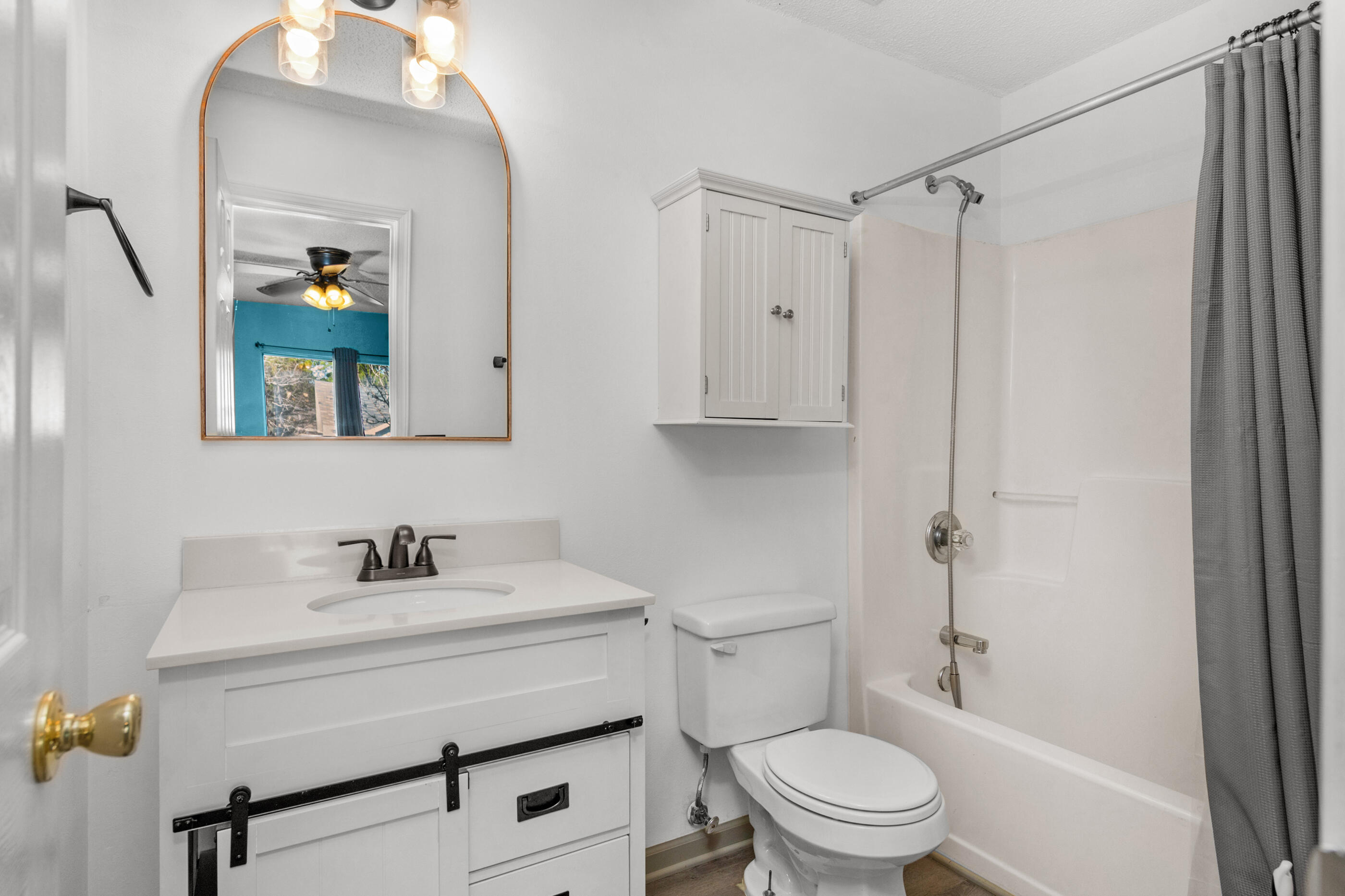 1810 Pointed Leaf Lane Fort Walton Beach, FL 32547 - Photo 3 of 24 a bathroom with a sink a toilet and shower curtain