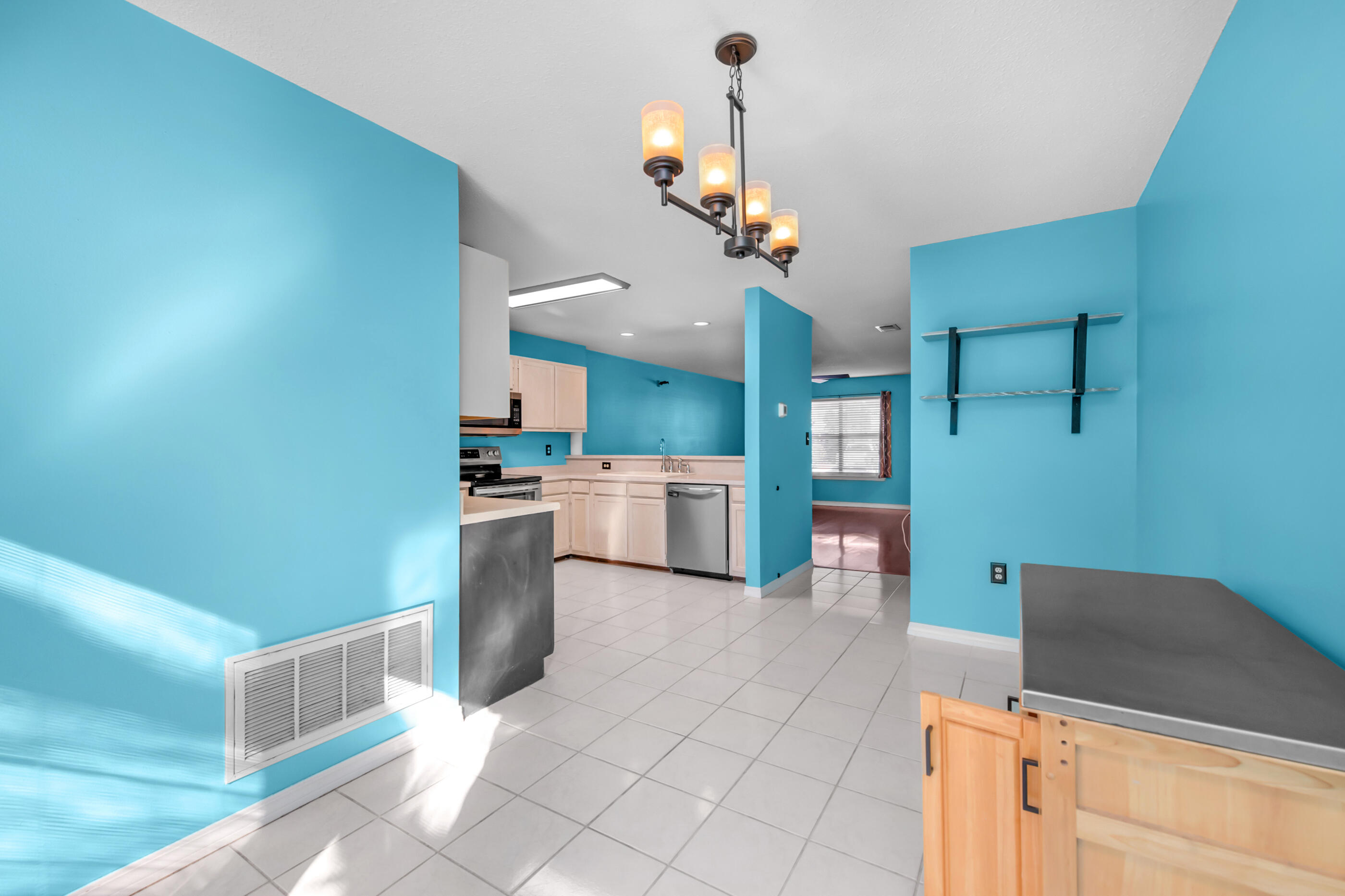 1810 Pointed Leaf Lane Fort Walton Beach, FL 32547 - Photo 6 of 24 a kitchen with cabinets and chairs