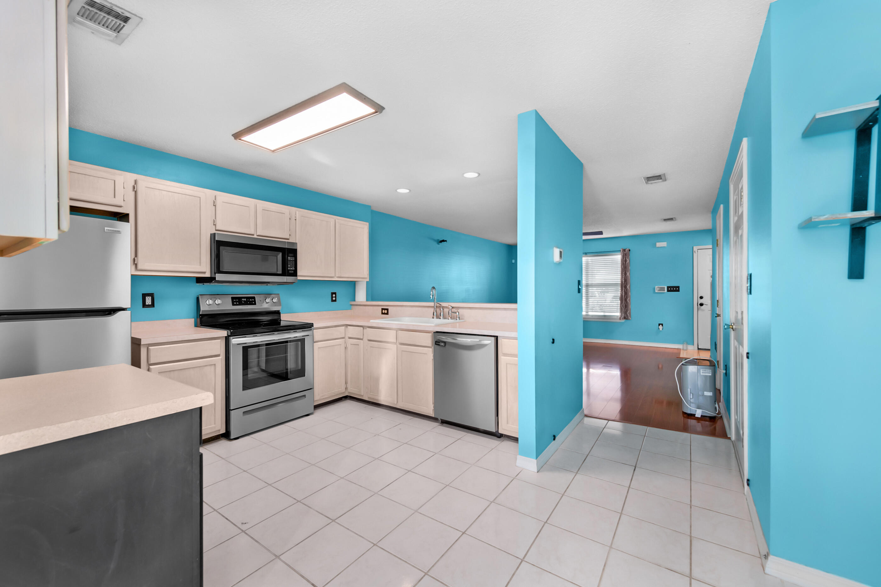 1810 Pointed Leaf Lane Fort Walton Beach, FL 32547 - Photo 7 of 24 a kitchen with a sink a counter top space stainless steel appliances and cabinets