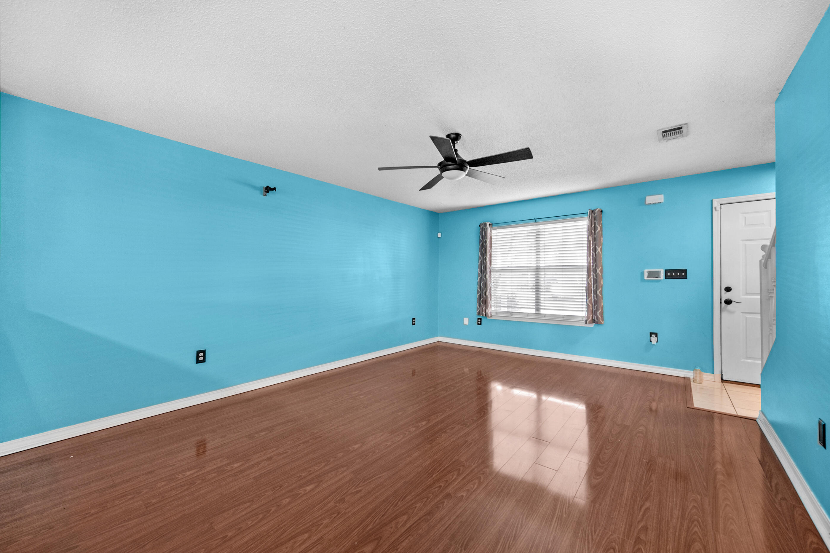 1810 Pointed Leaf Lane Fort Walton Beach, FL 32547 - Photo 9 of 24 a view of empty room with wooden floor and fan
