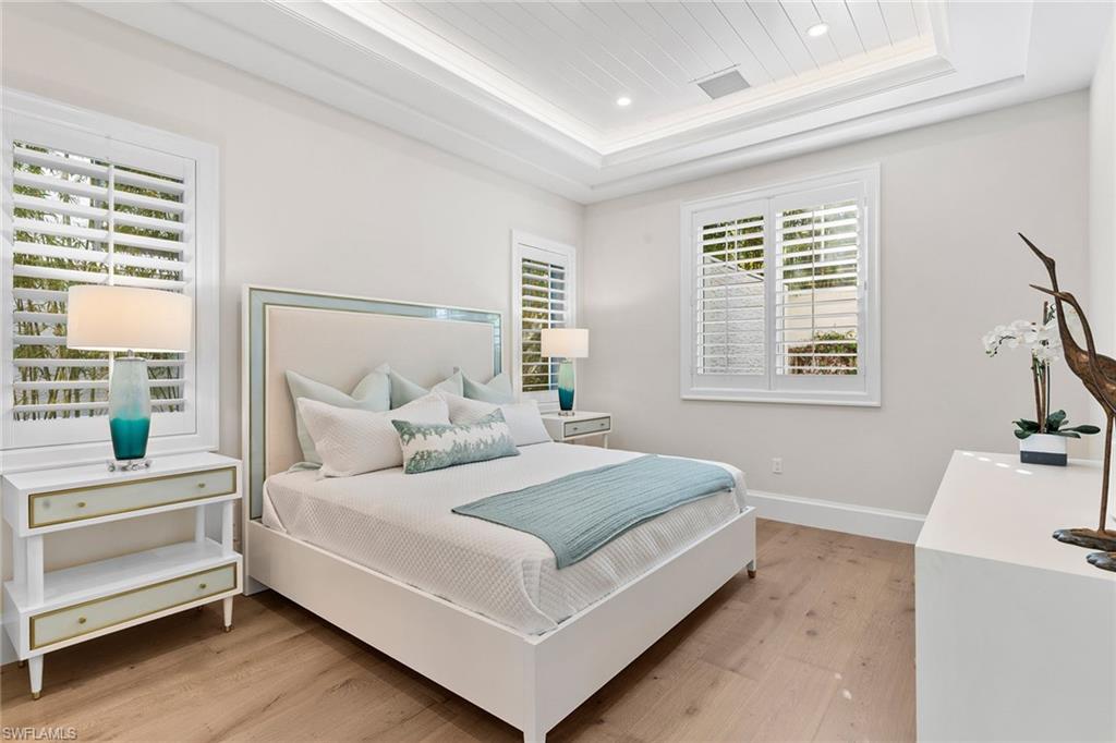 810 9th Street South Naples, FL 34102 - Photo 12 of 32 a bedroom with a bed and a dresser