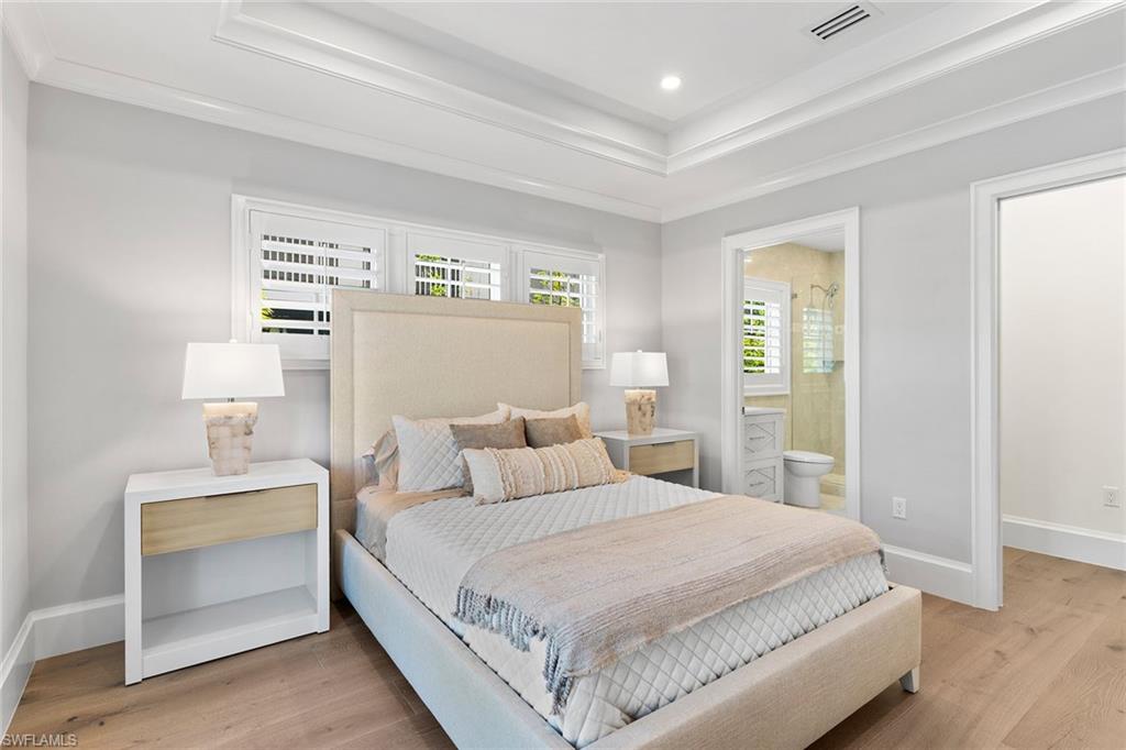 810 9th Street South Naples, FL 34102 - Photo 20 of 32 a bedroom with a bed and a night stand