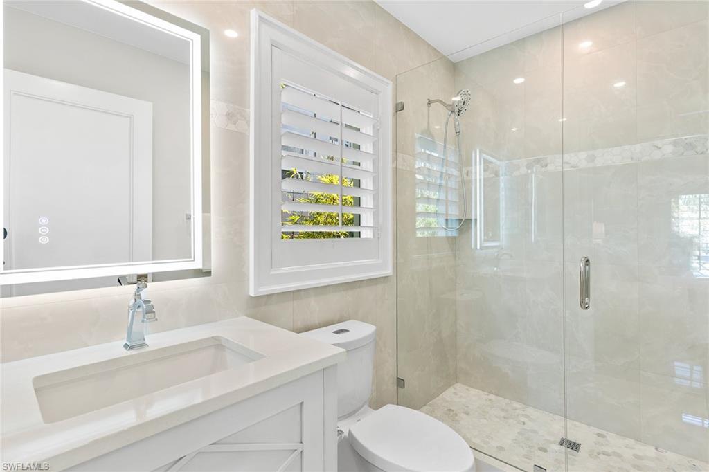 810 9th Street South Naples, FL 34102 - Photo 21 of 32 a bathroom with a sink toilet and shower