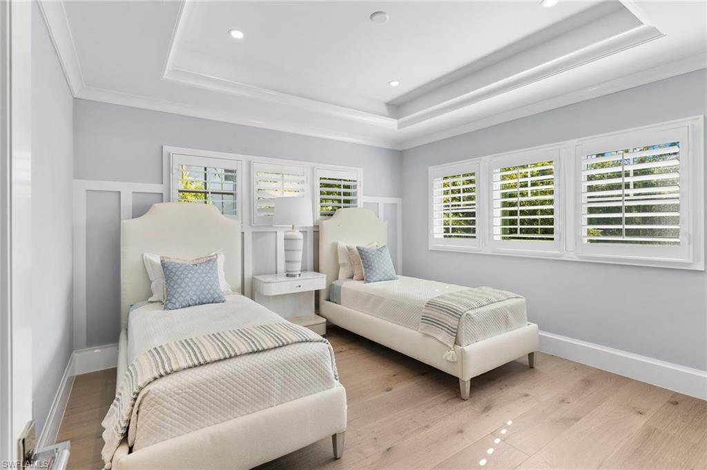 810 9th Street South Naples, FL 34102 - Photo 22 of 32 a bedroom with two beds and a window