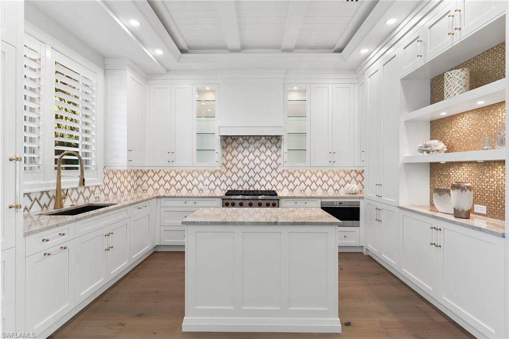 810 9th Street South Naples, FL 34102 - Photo 8 of 32 a kitchen with a sink stove and cabinets