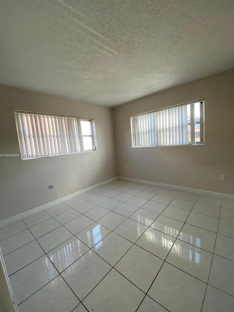 2441 Northwest 13th Street, Unit 71 Miami, FL 33125 - Photo 12 of 12 an empty room with windows