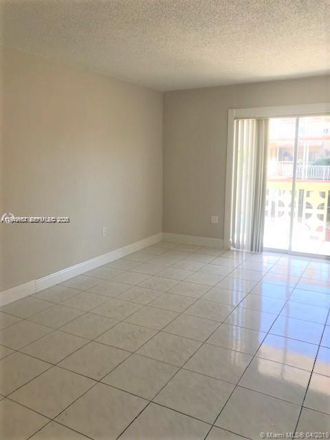 2441 Northwest 13th Street, Unit 71 Miami, FL 33125 - Photo 6 of 12 an empty room with windows