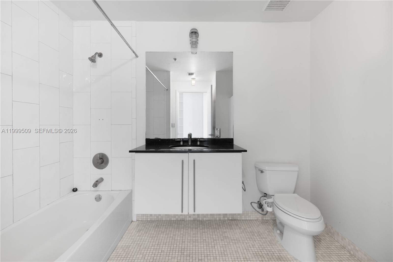8101 Biscayne Boulevard, Unit R414 Miami, FL 33138 - Photo 17 of 27 a bathroom with a toilet a sink and bathtub