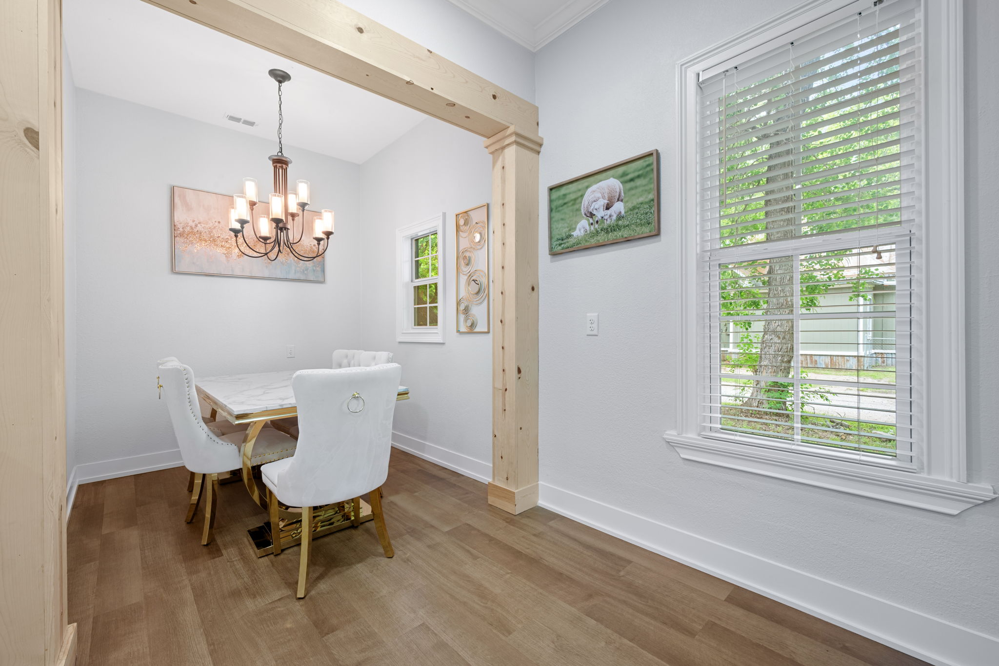 602 East 6th Street Cameron, TX 76520 - Photo 22 of 40 Dining area featuring wood-finish flooring, a decorative wood beam, crown molding, and a substantial window with blinds