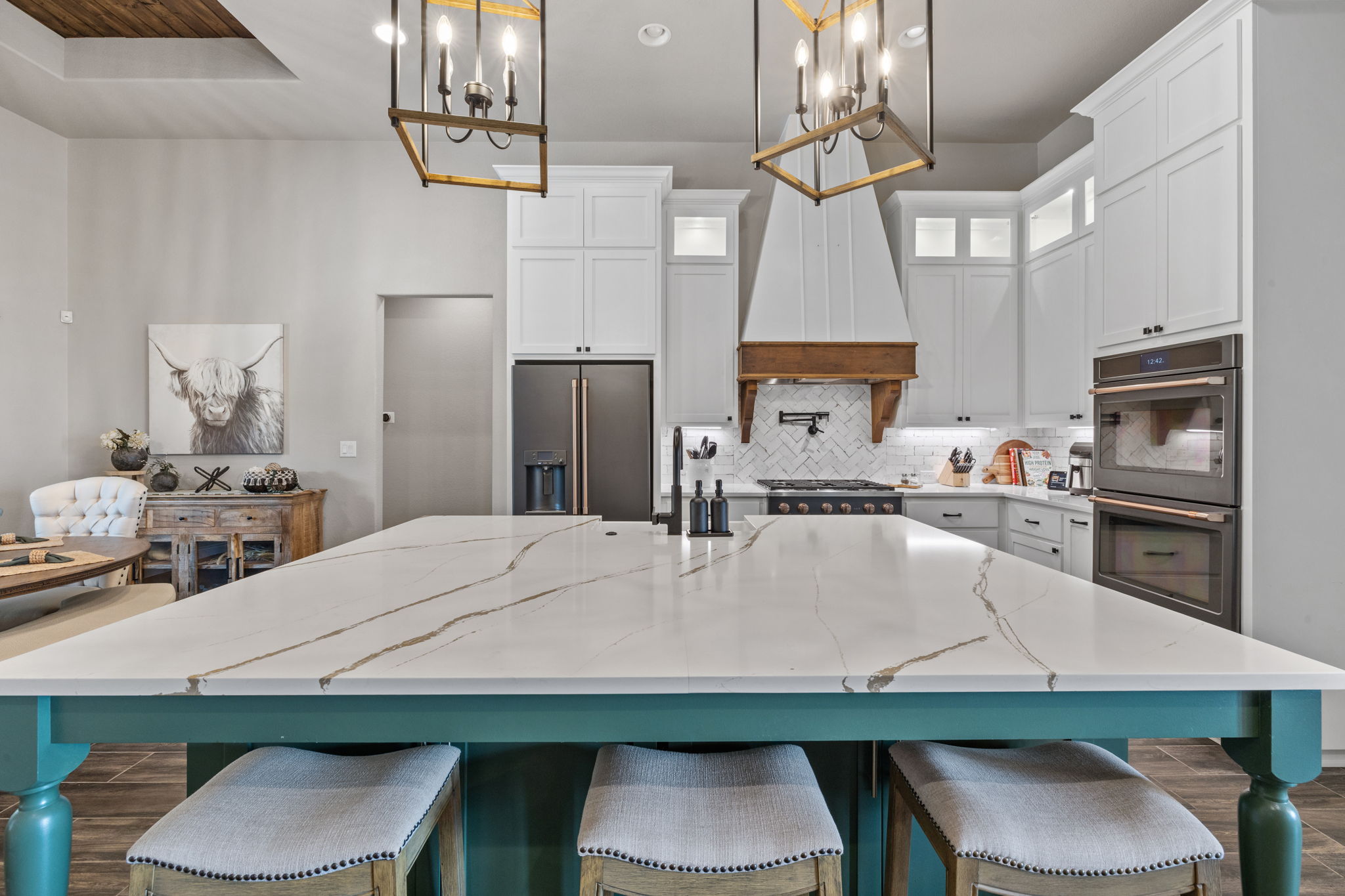 104 Lower Cedar Cove Georgetown, TX 78633 - Photo 12 of 37 a kitchen with stainless steel appliances a table chairs and chandelier