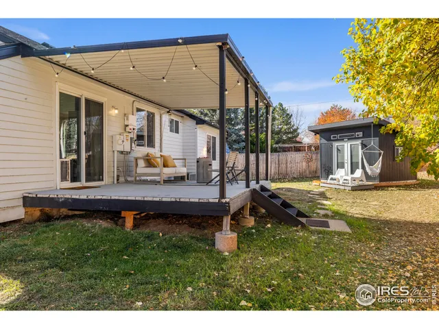 a view of a backyard with a small cabin