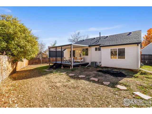 a backyard of a house with barbeque oven table and chairs