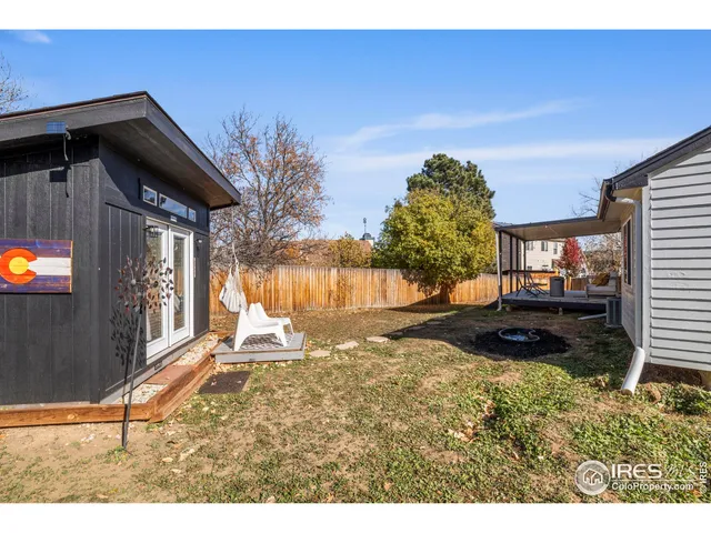 a view of a house with backyard and swimming pool