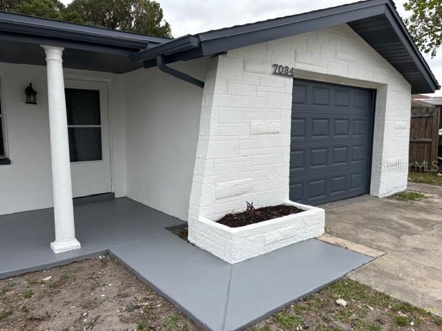 7034 Coral Reef Drive Port Richey, FL 34668 - Photo 5 of 9 a front view of a house with a yard