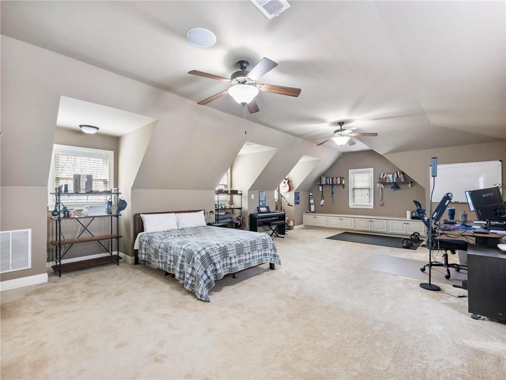 6147 Golf View Court Jefferson, GA 30549 - Photo 39 of 73 a spacious bedroom with a bed a chandelier and dresser