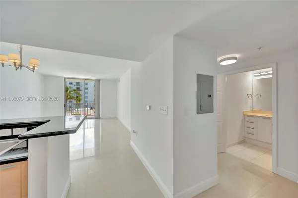 a view of a kitchen with white cabinets and stainless steel appliances