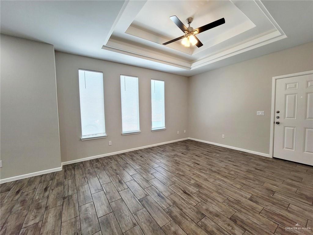 1312 Petri Drive, Unit 2 Weslaco, TX 78596 - Photo 11 of 15 an empty room with wooden floor and ceiling fan