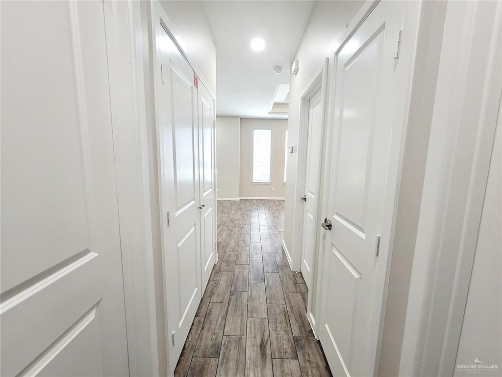1312 Petri Drive, Unit 2 Weslaco, TX 78596 - Photo 12 of 15 a view of a hallway with wooden floor and staircase
