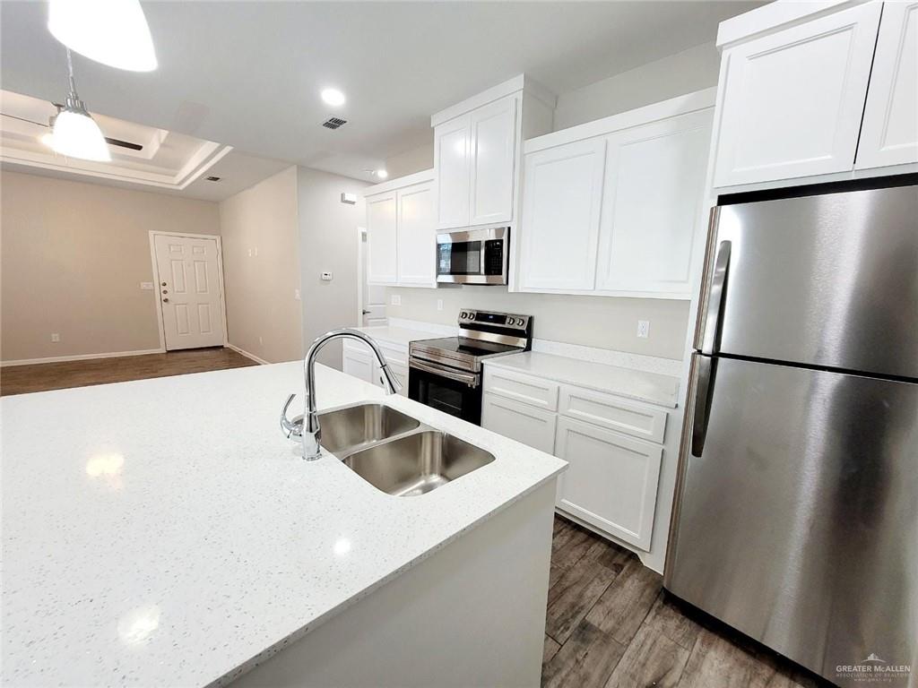 1312 Petri Drive, Unit 2 Weslaco, TX 78596 - Photo 7 of 15 a kitchen with a refrigerator a sink and a stove