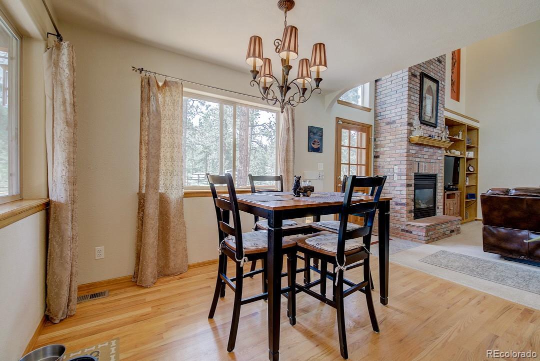25 Buggy Whip Road Bailey, CO 80421 - Photo 15 of 40 a view of a dining room with furniture window and wooden floor