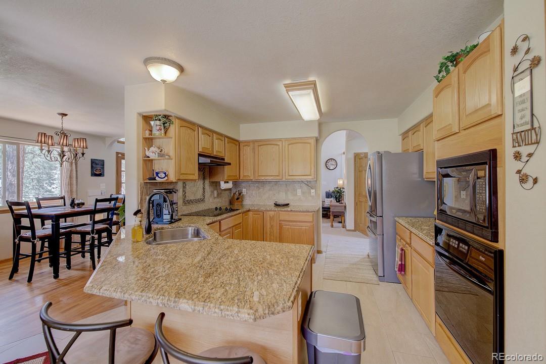 25 Buggy Whip Road Bailey, CO 80421 - Photo 16 of 40 a large kitchen with a table and chairs