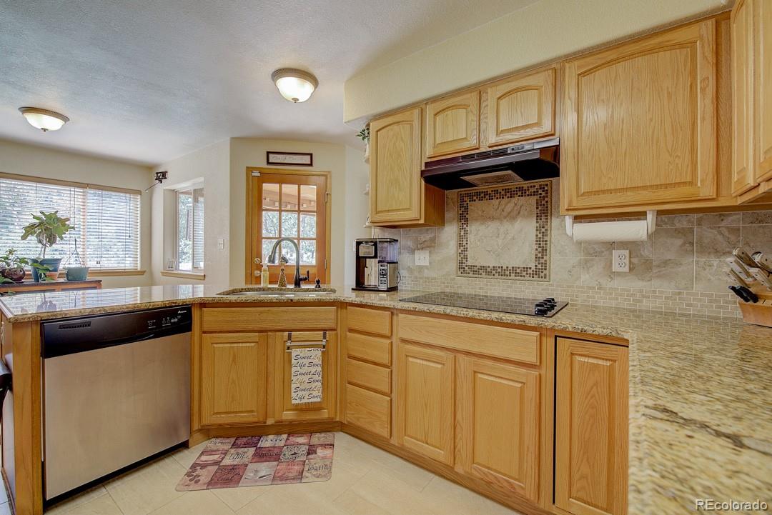 25 Buggy Whip Road Bailey, CO 80421 - Photo 17 of 40 a kitchen with a sink stove and cabinets