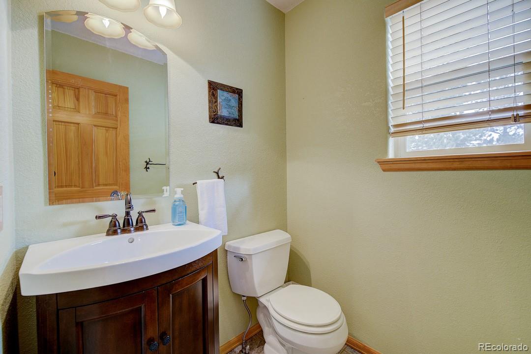 25 Buggy Whip Road Bailey, CO 80421 - Photo 23 of 40 a bathroom with a sink a toilet and mirror