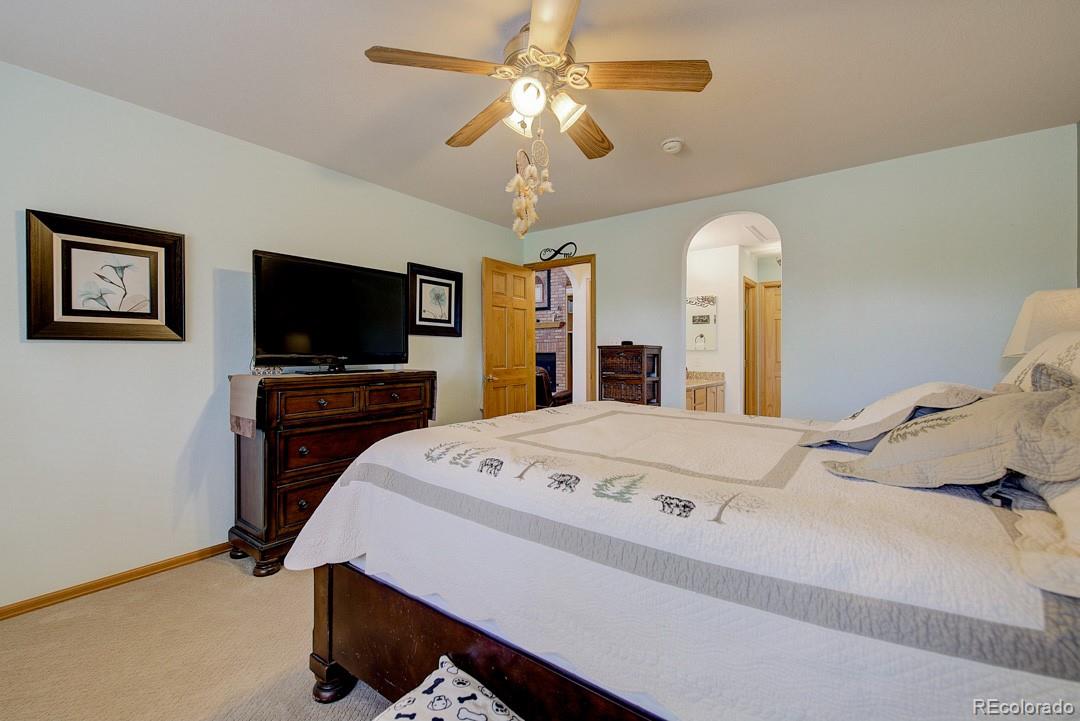 25 Buggy Whip Road Bailey, CO 80421 - Photo 24 of 40 a bedroom with a bed and a flat screen tv