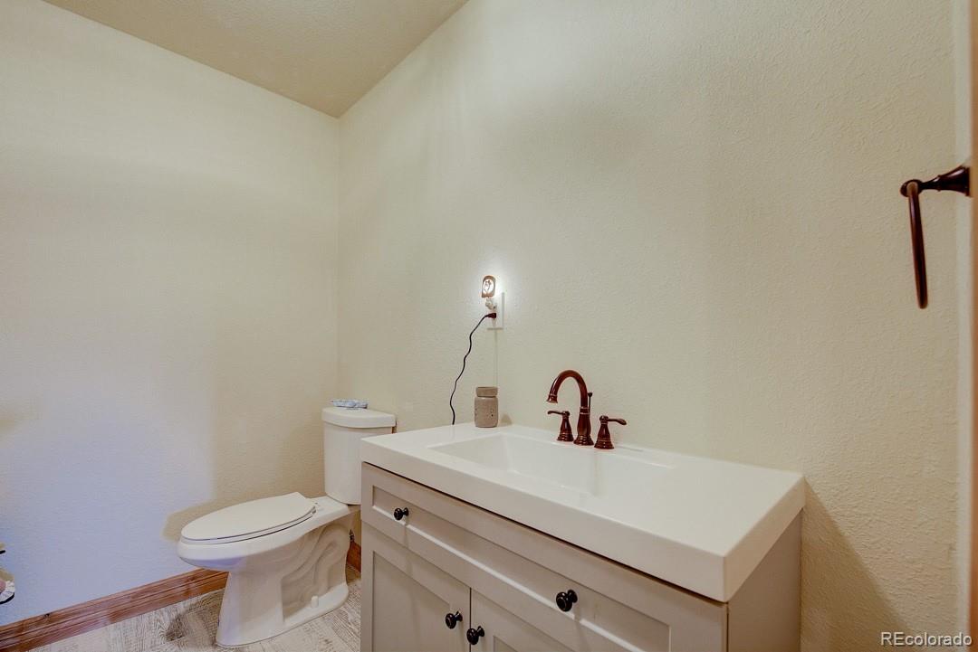 25 Buggy Whip Road Bailey, CO 80421 - Photo 31 of 40 a bathroom with a sink a toilet and mirror