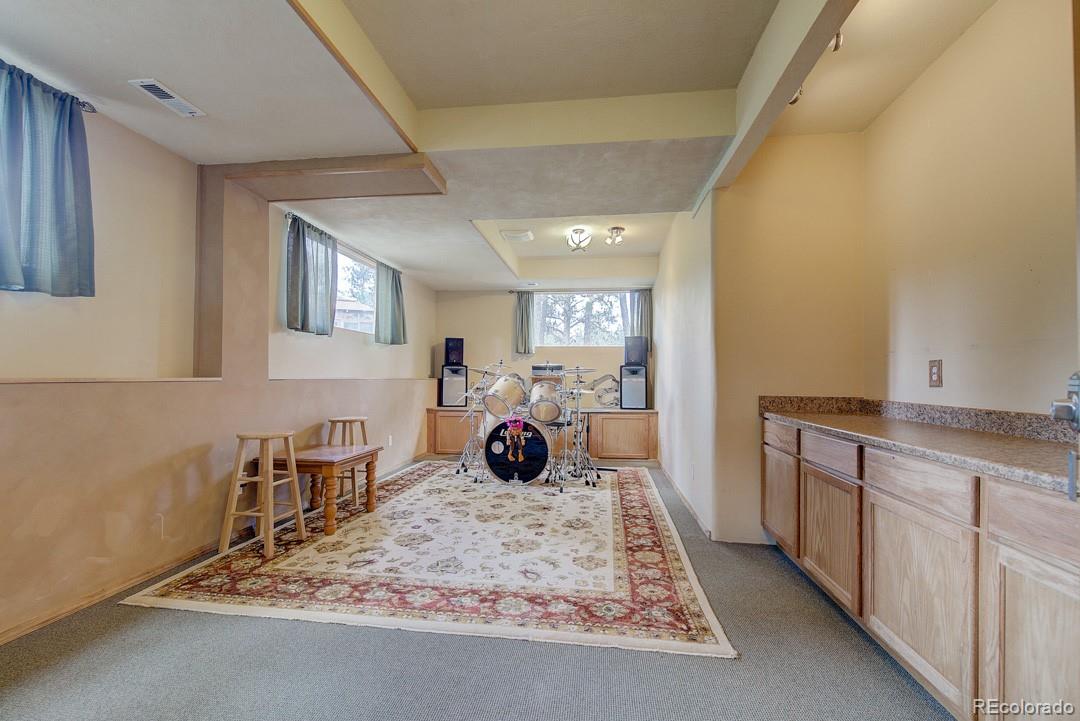 25 Buggy Whip Road Bailey, CO 80421 - Photo 9 of 40 a bed room with a bed and a chair
