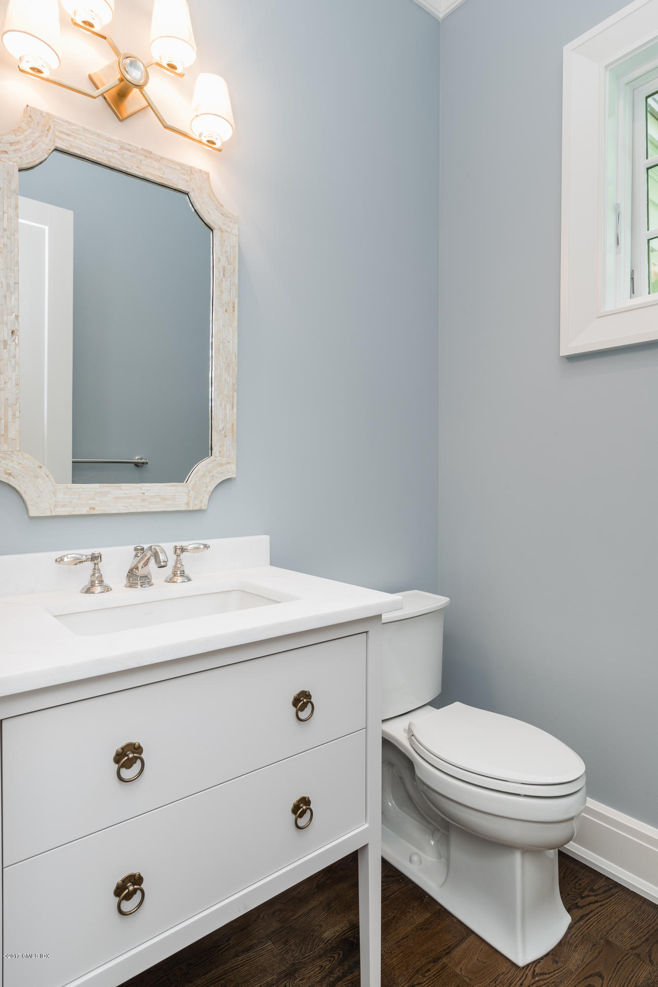 9 Shaw Place Riverside, CT 06878 - Photo 12 of 39 a bathroom with a toilet a sink a mirror and vanity