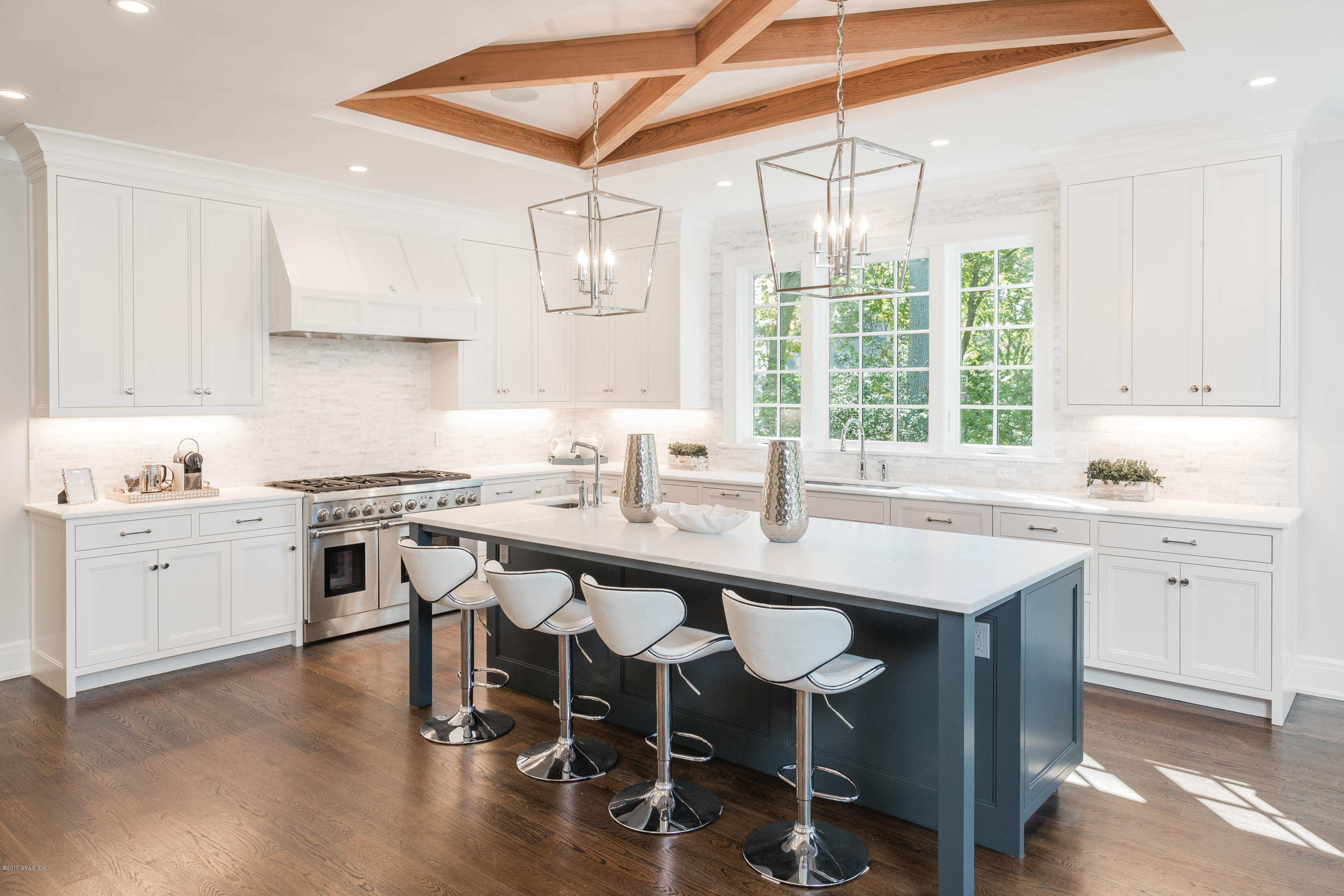 9 Shaw Place Riverside, CT 06878 - Photo 16 of 39 a kitchen with a sink a stove a dining table and chairs