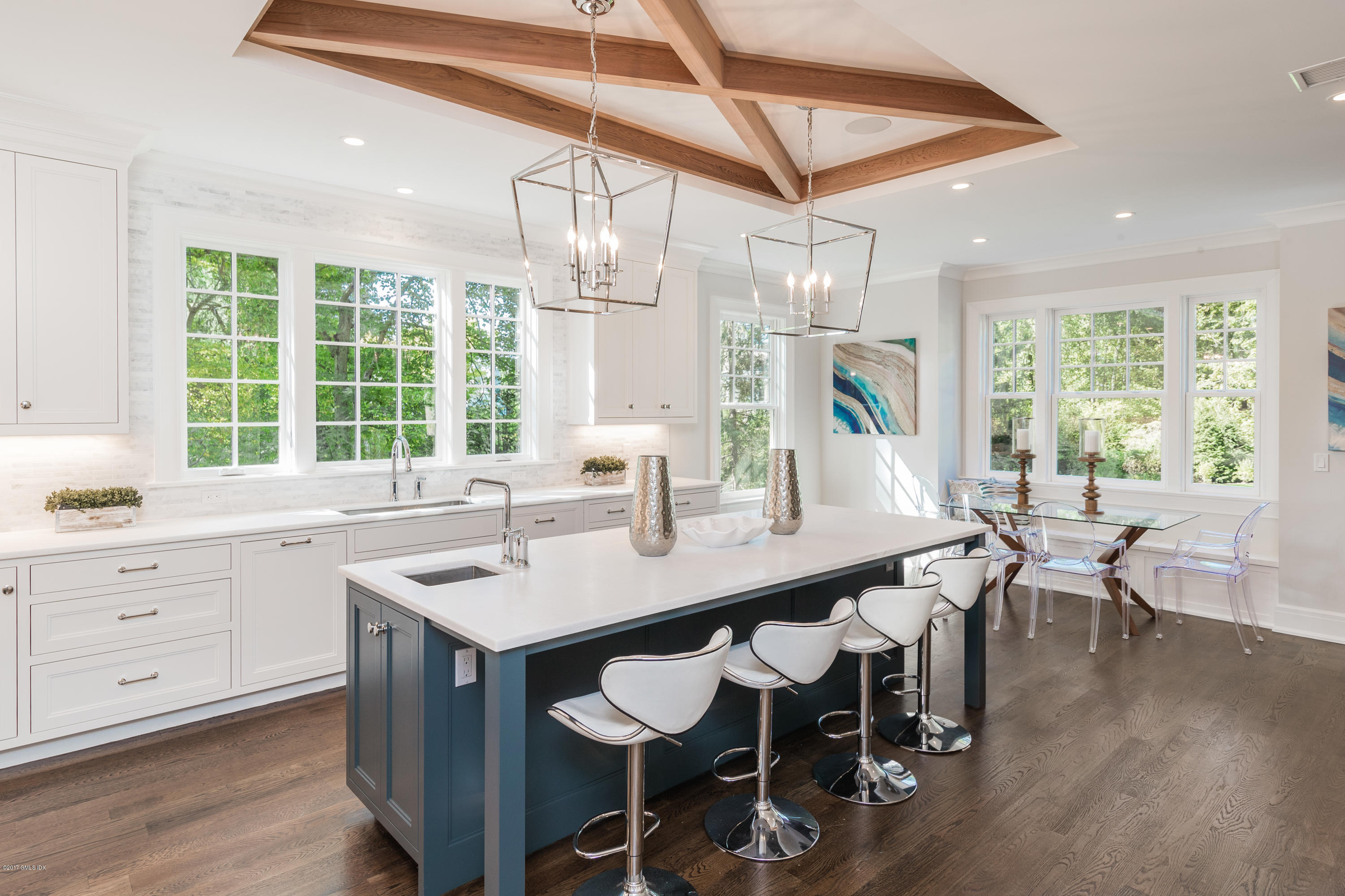 9 Shaw Place Riverside, CT 06878 - Photo 18 of 39 a kitchen with a dining table chairs sink and white cabinets