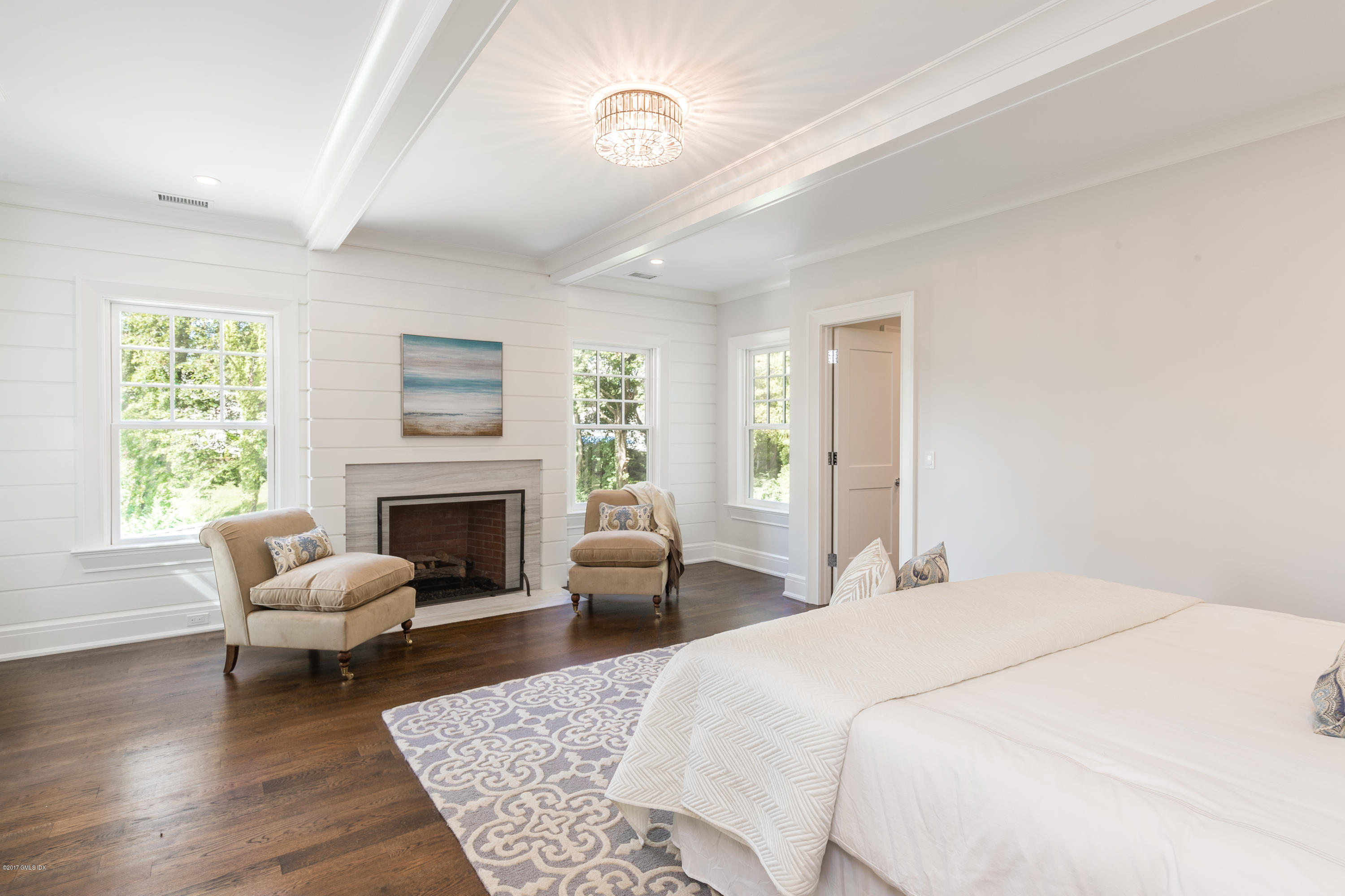 9 Shaw Place Riverside, CT 06878 - Photo 24 of 39 a spacious bedroom with a bed and a fireplace