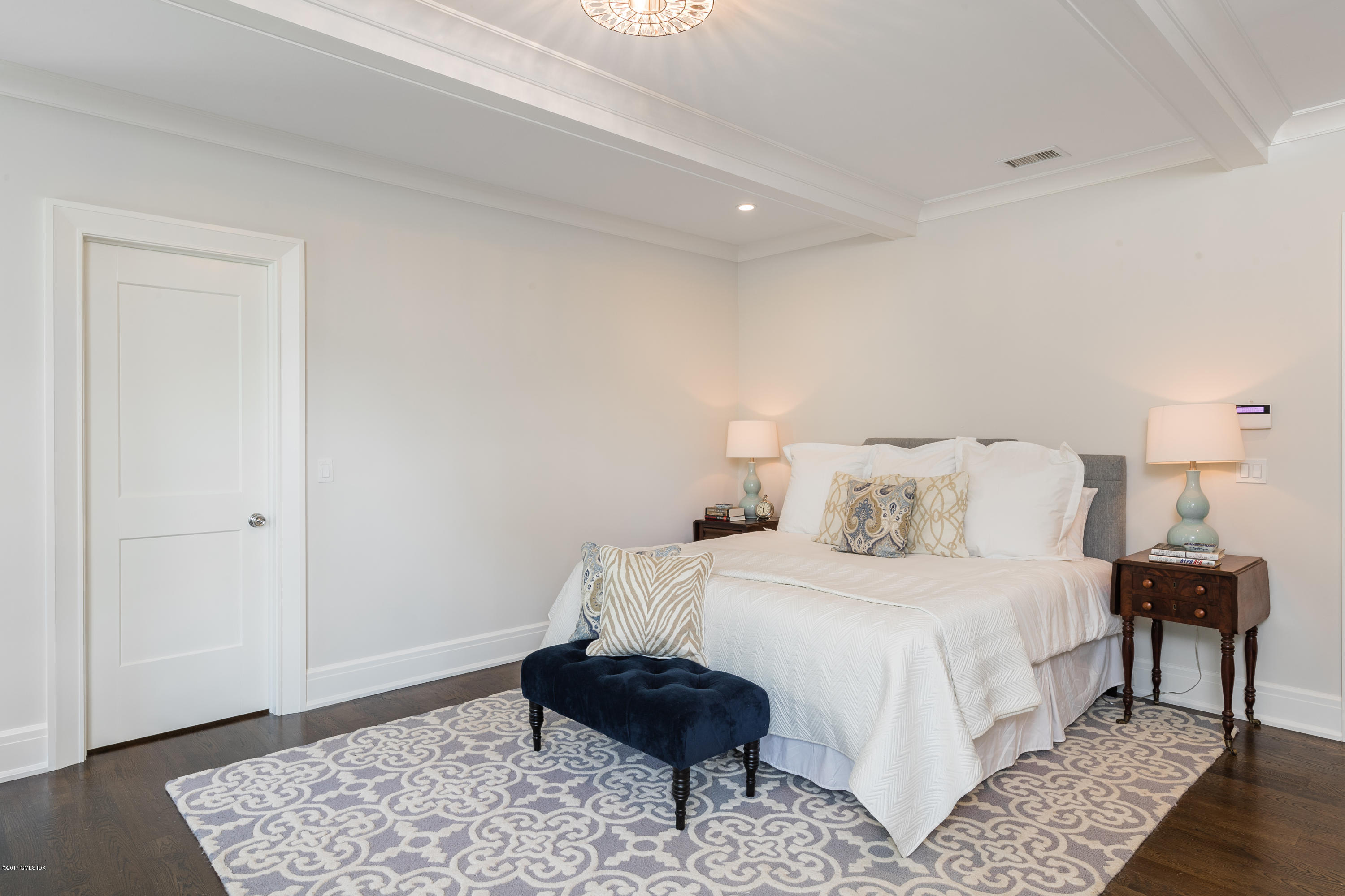 9 Shaw Place Riverside, CT 06878 - Photo 25 of 39 a bedroom with a bed and wooden floor